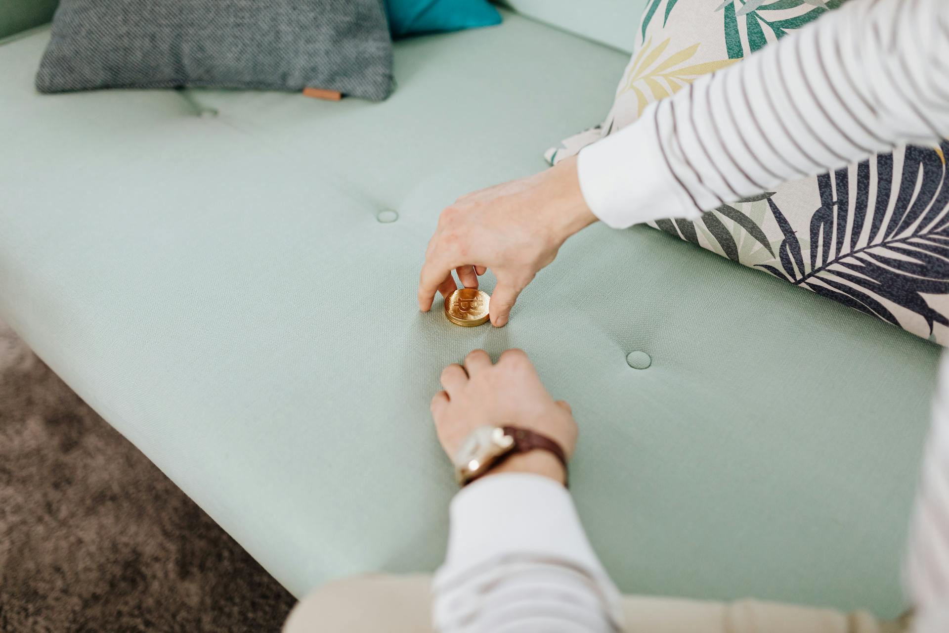 Stacked of Gold Coins on Green Couch