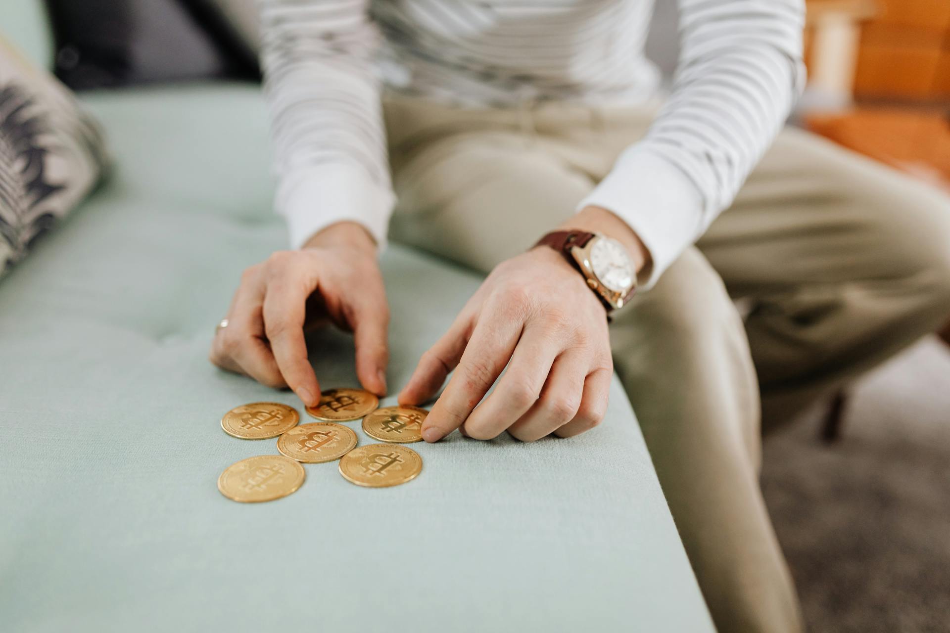 Hands Holding Gold Round Coins