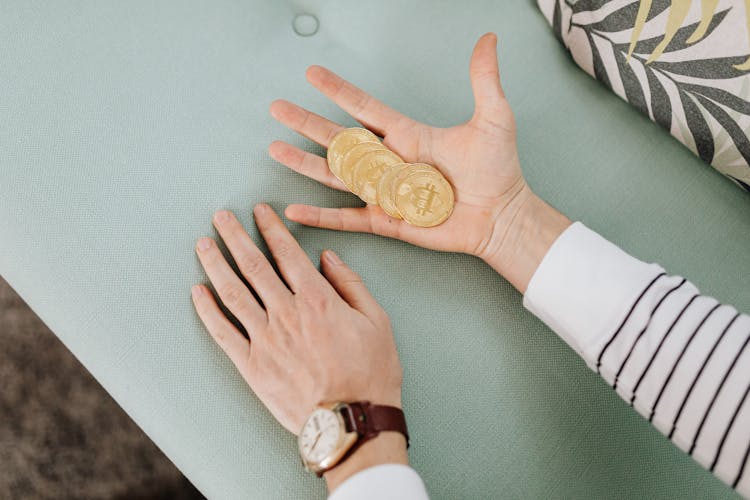 Gold Coins On The Person's Palm 