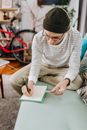 Man in Striped Long Sleeve Shirt Writing a List