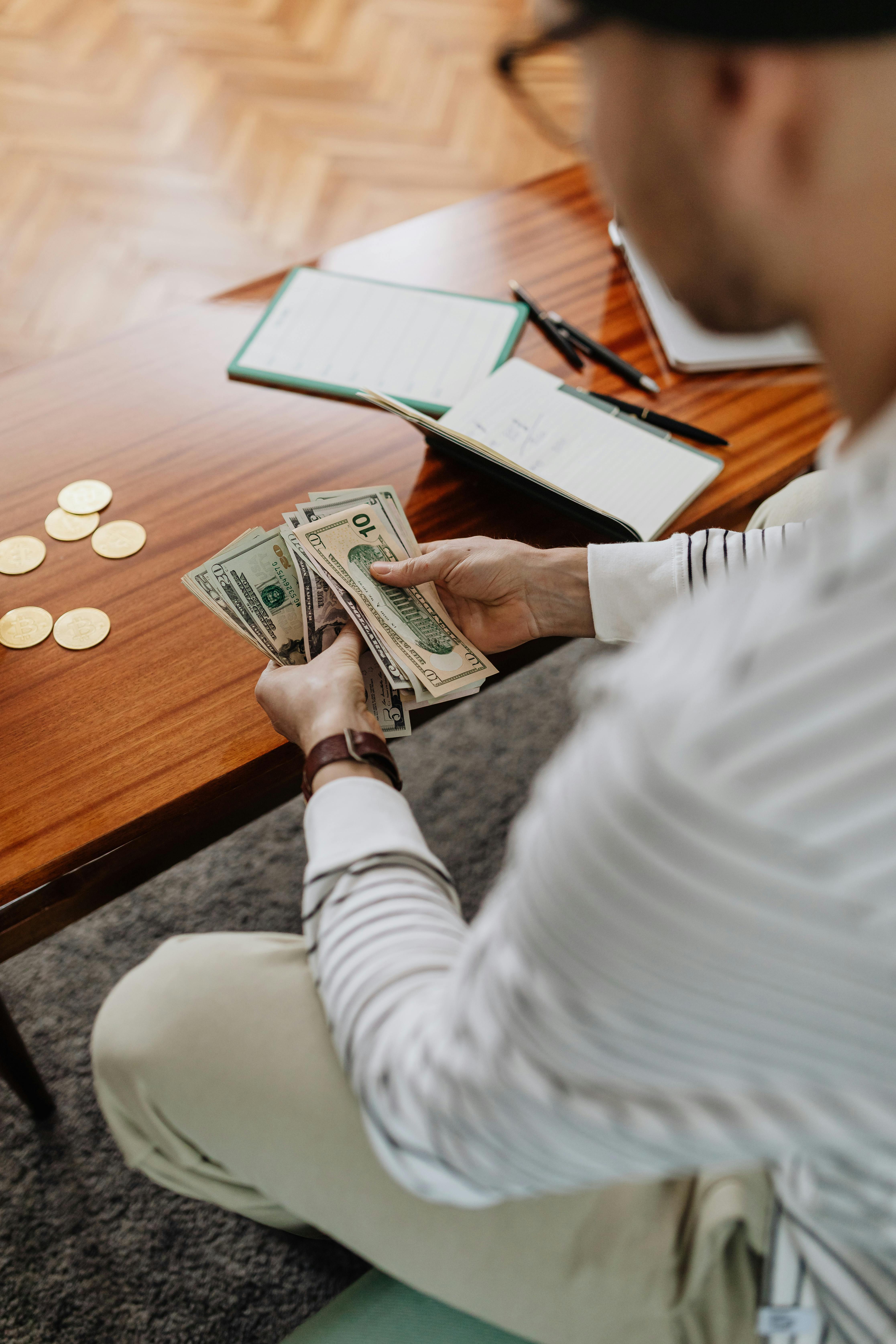 Woman Holding Fan of US Dollar Bills · Free Stock Photo