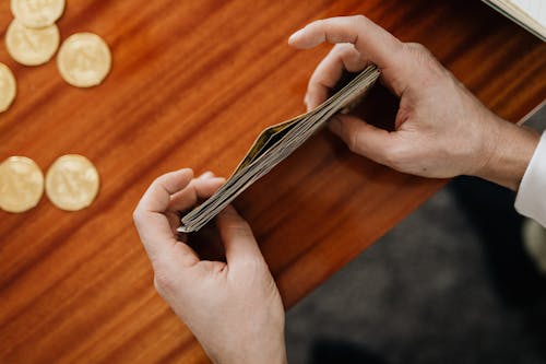 A Person Stacking Paper Bills Money