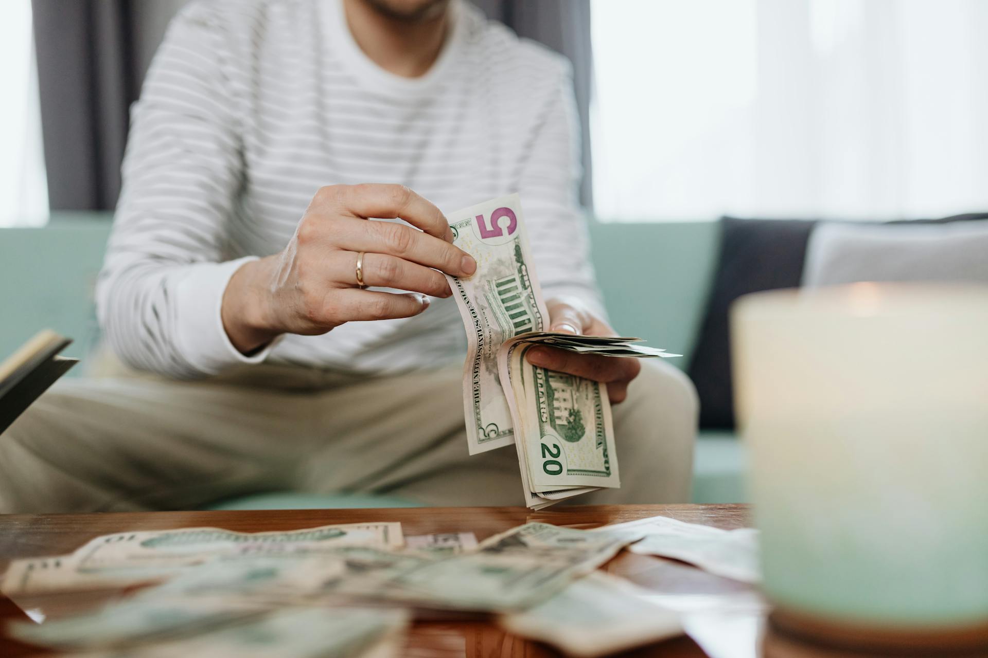 A Person Counting His Money