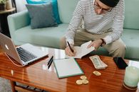 Man Writing on a Notebook