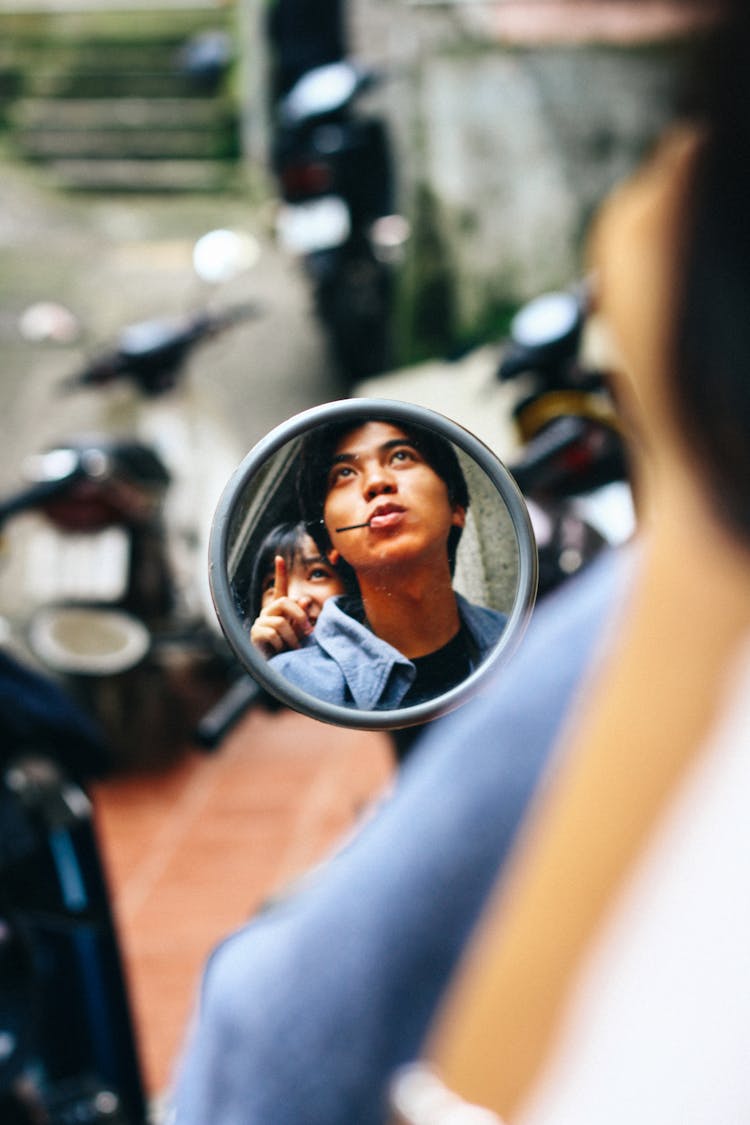 Asian Couple Riding Motorcycle In City