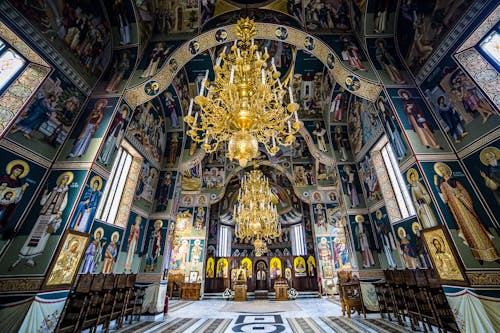 Gold Chandelier and Green Blue and White Wall