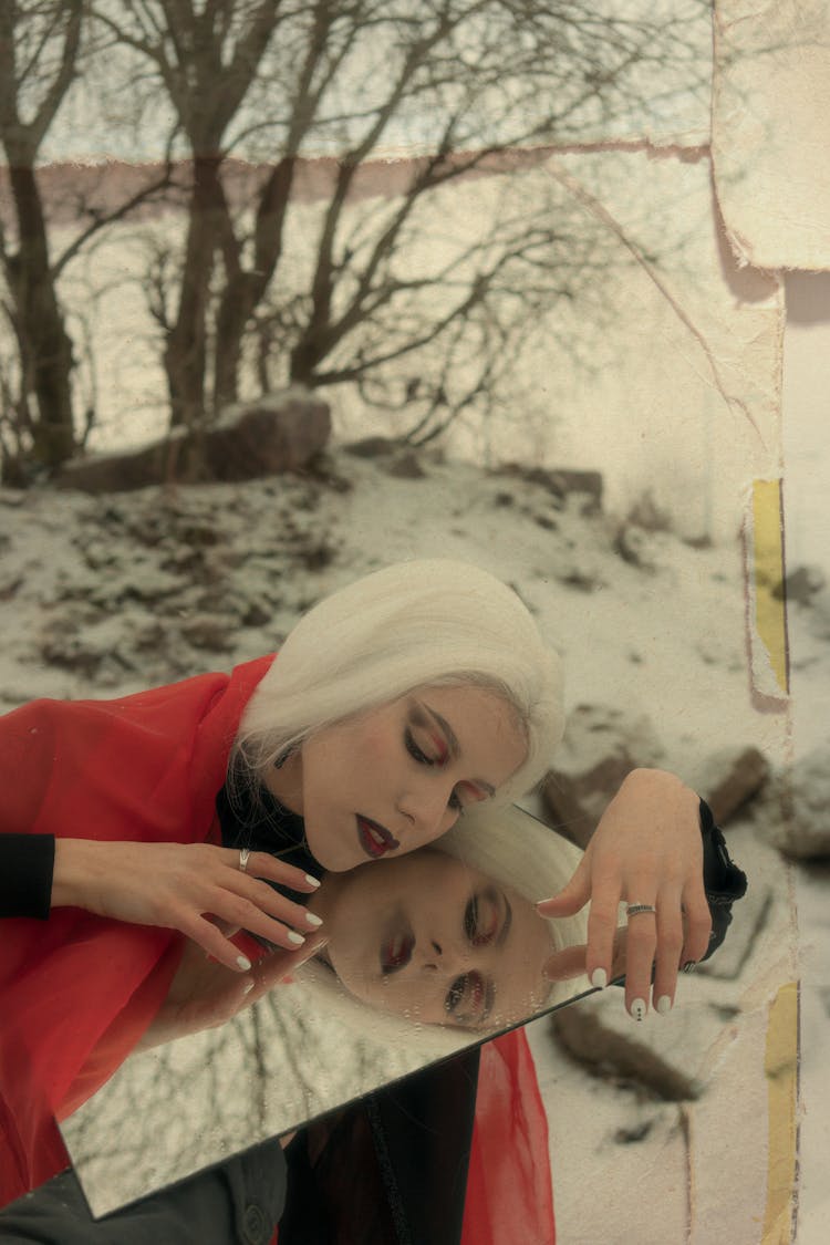 Dreamy Gothic Woman With Mirror Relaxing In Snowy Nature