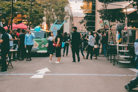 Busy street food scene in Mandau Talawang, Central Kalimantan, Indonesia at twilight.