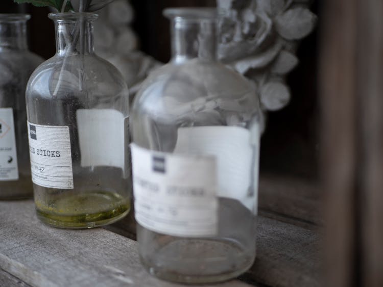 Dusty Glass Bottles On Wooden Surface