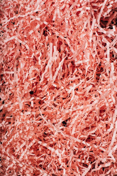 Free From above heap of shredded crinkled pink paper filler for gift box as abstract background Stock Photo