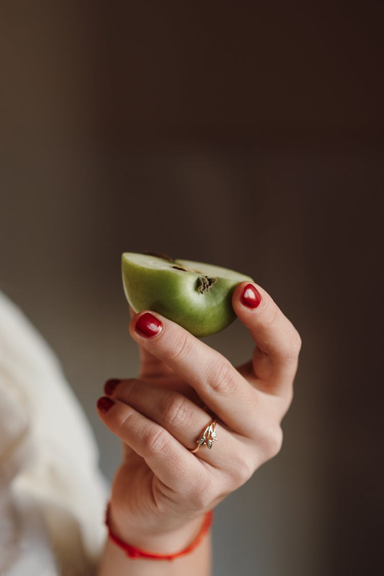 Female Holding Half Of Ripe Apple