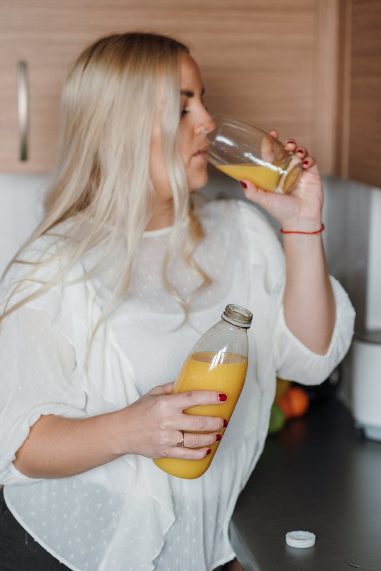 Calm Woman Drinking Homemade Orange Juice