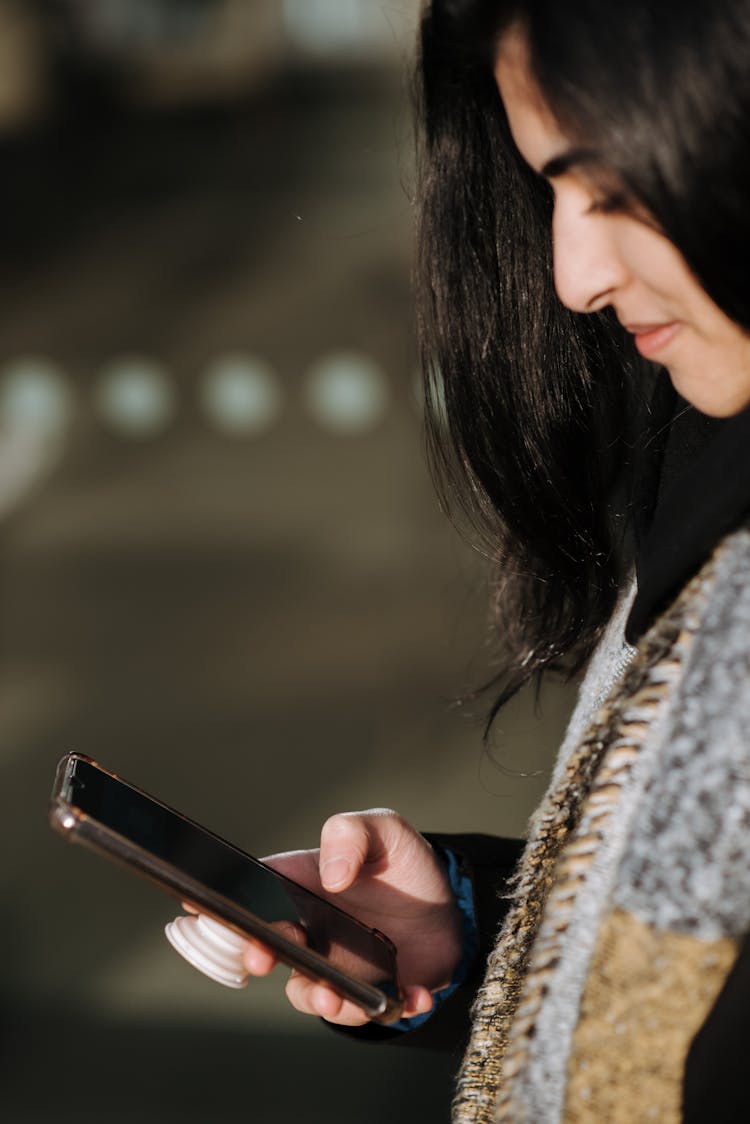 Crop Hispanic Woman Surfing Internet On Smartphone Outdoors