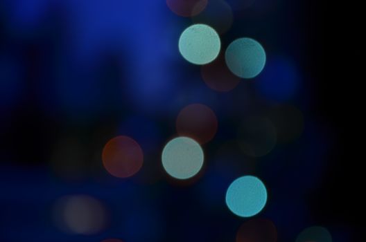 A dreamy abstract background featuring colorful bokeh lights in diverse hues.