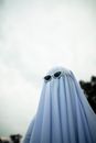 Little kid playing imaginary ghost in park
