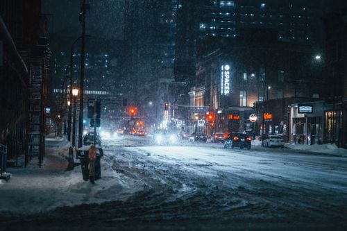 Free A snowy evening on an urban street in downtown Minneapolis, captured with streetlights illuminating the falling snow. Stock Photo
