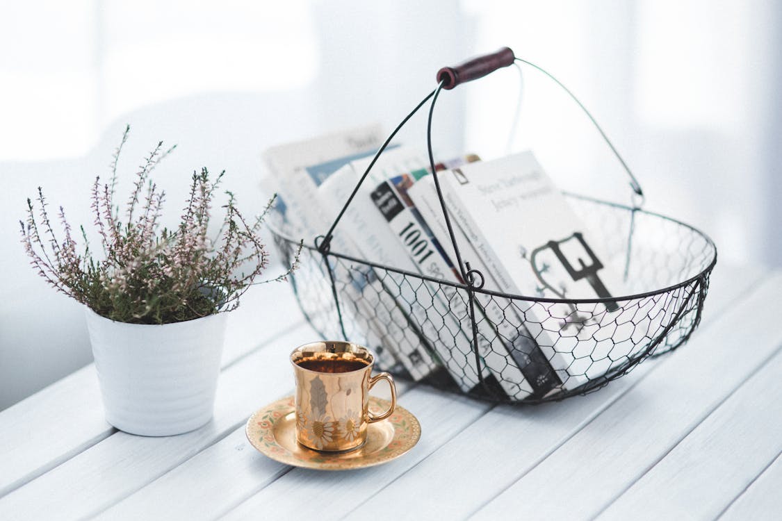 Free Golden cup and basket with books Stock Photo
