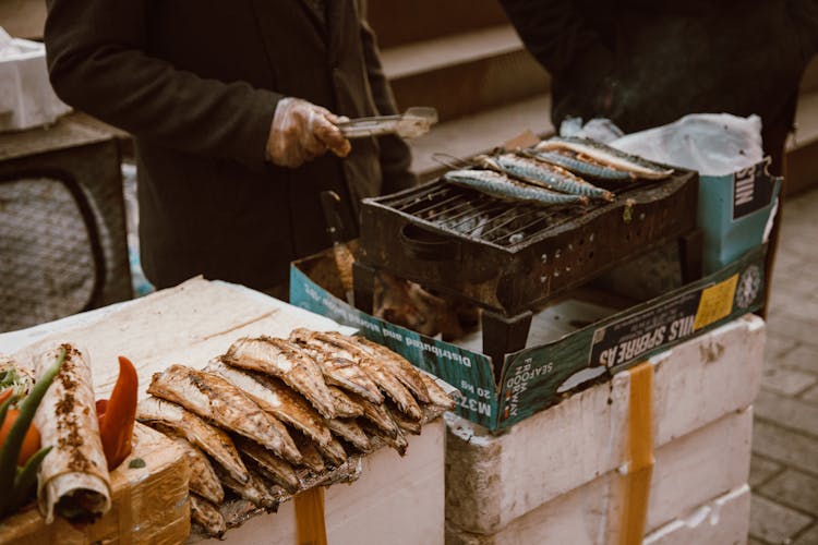 Person Grilling Fish