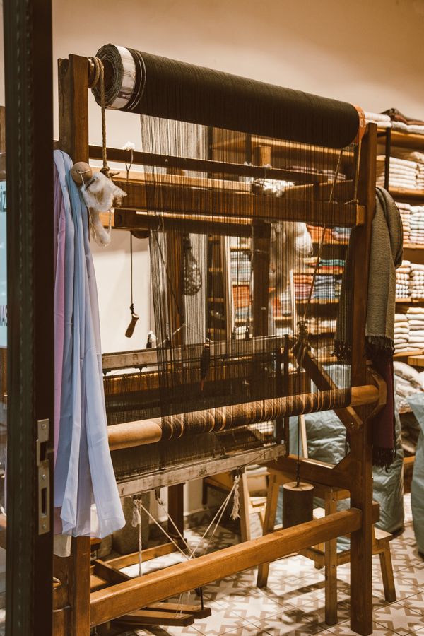 Warp threads on a wooden floor loom — photo by ROMAN ODINTSOV on Pexels