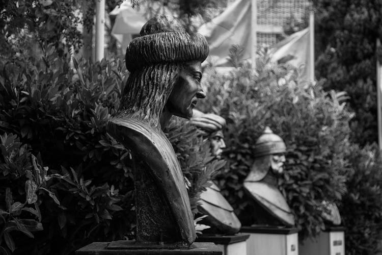 Head Statues Of Men In A Garden