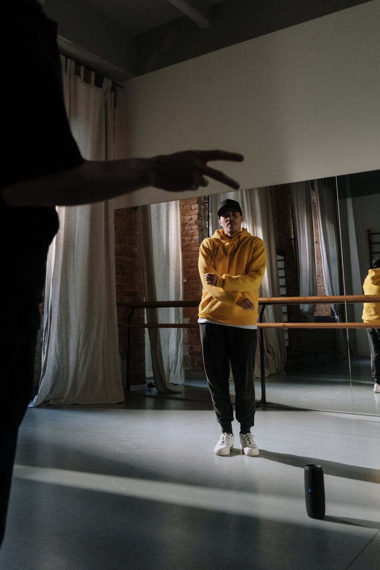 Man In Yellow Hoodie Sweater And Black Sweatpants Doing Dance Moves