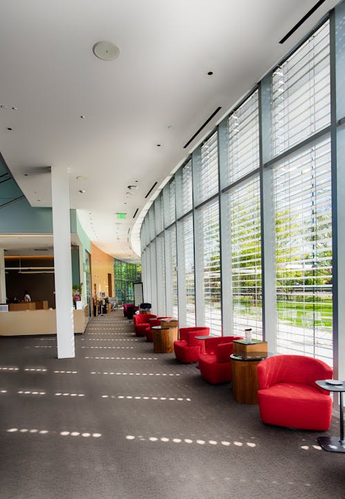 Red Sofa Chairs Beside Glass Wall Inside Building