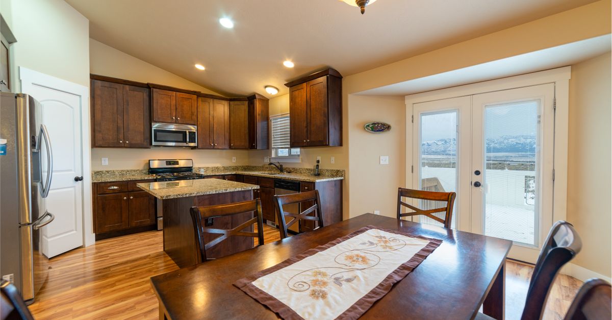 Spacious kitchen and dining area featuring modern appliances and wooden cabinets.