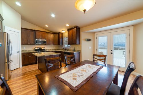 Free Spacious kitchen and dining area featuring modern appliances and wooden cabinets. Stock Photo