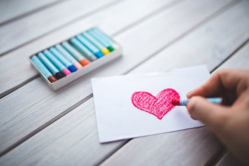 Free Hand with oil pastel draws the heart Stock Photo