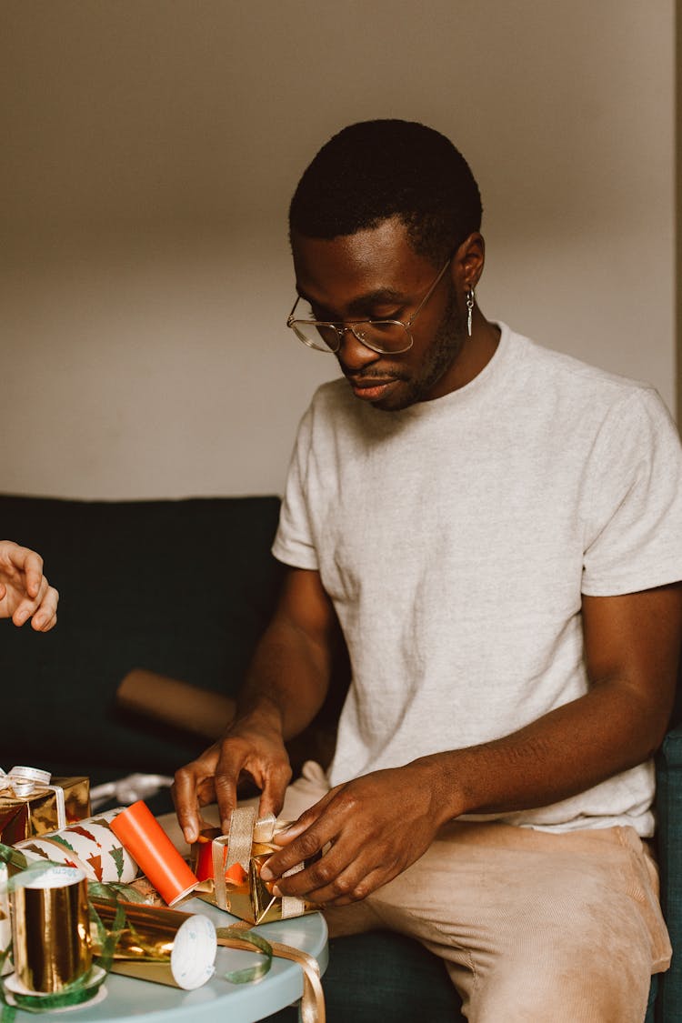 A Man Wrapping A Christmas Gift