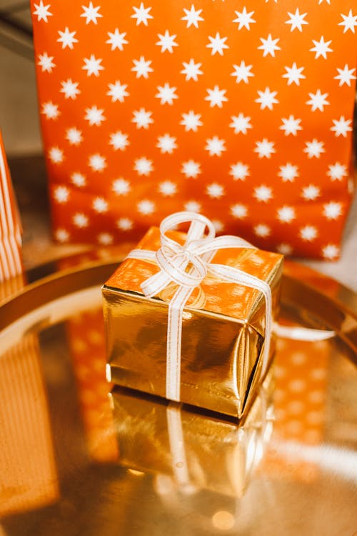 Free A Gold Gift Box on the Table Stock Photo