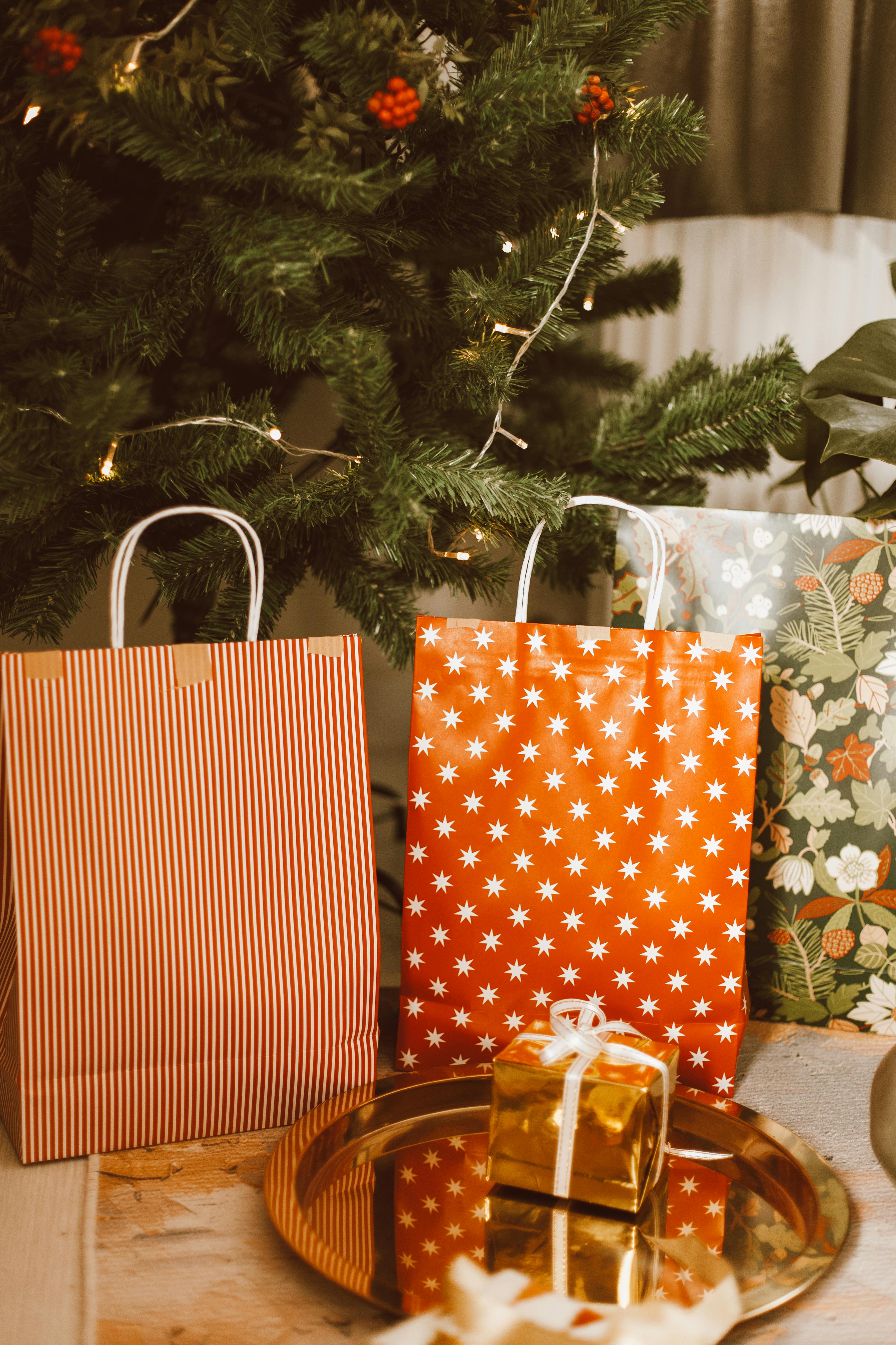 a gold gift box near the paper bags