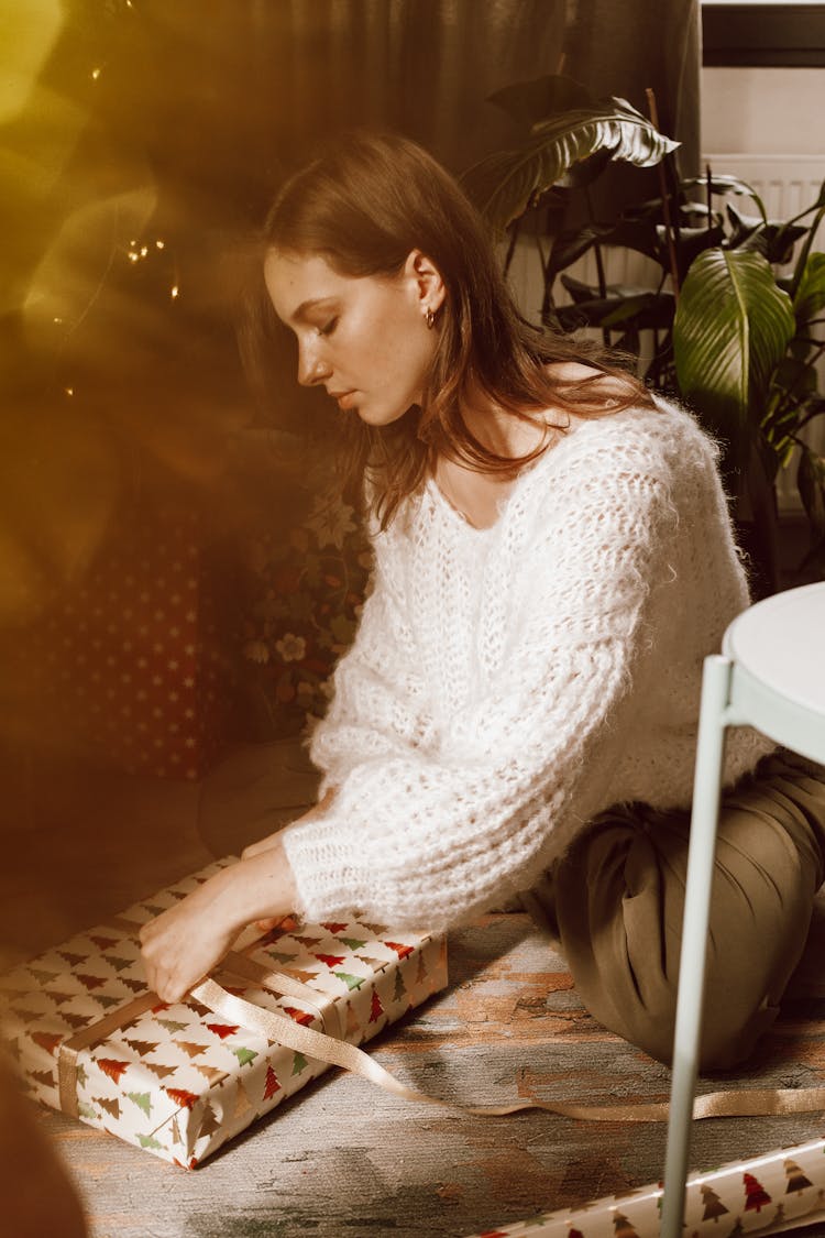 Brunette Woman Wrapping Christmas Gift