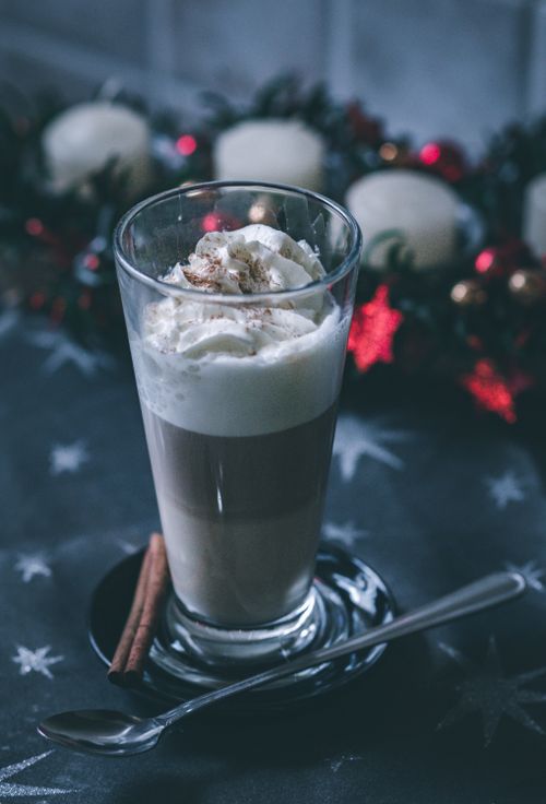 Free Delicious creamy coffee topped with whipped cream and cinnamon, perfect for the holiday season. Stock Photo