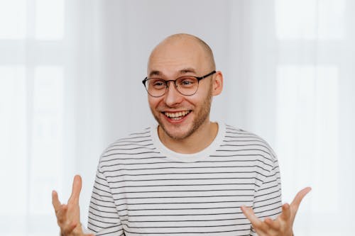 Man in White and Black Striped Shirt Smiling