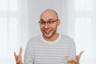 Man in White and Black Striped Shirt Smiling