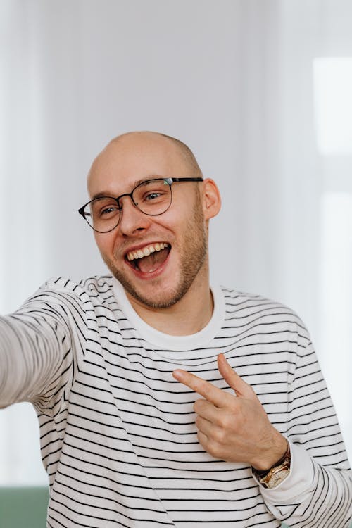 Man in Black and White Striped Shirt Laughing