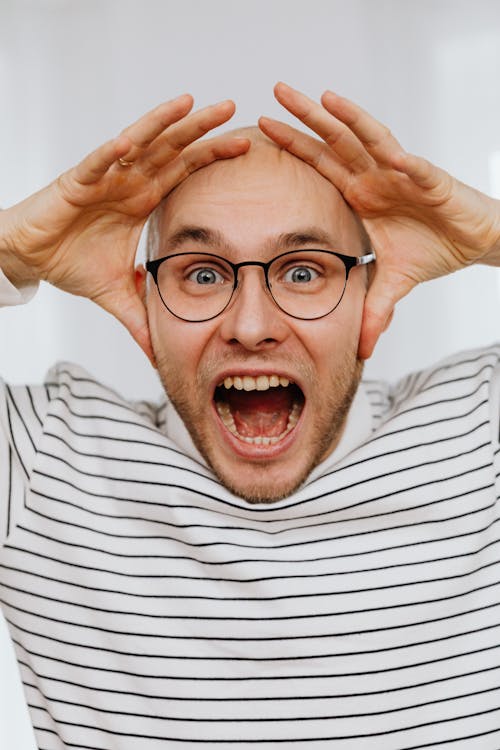 Free Man with Hands on Head Yelling  Stock Photo