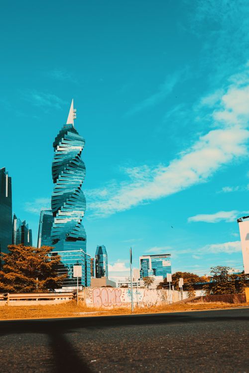 Free Panama City's iconic skyscraper showcasing its unique, twisting architecture against a clear blue sky. Stock Photo