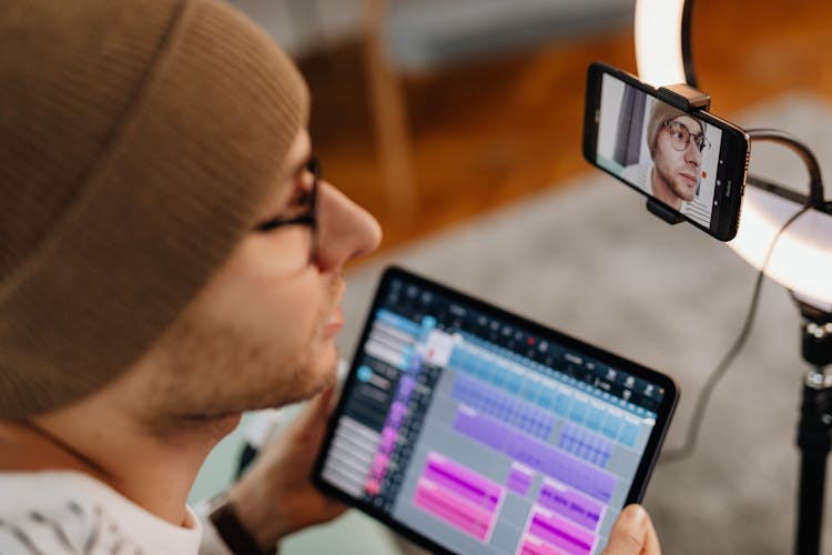 A Man Using Tablet And Smartphone 