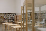 Brown Wooden Book Shelf Near White Wall
