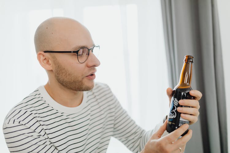 A Man Holding Beer Bottle