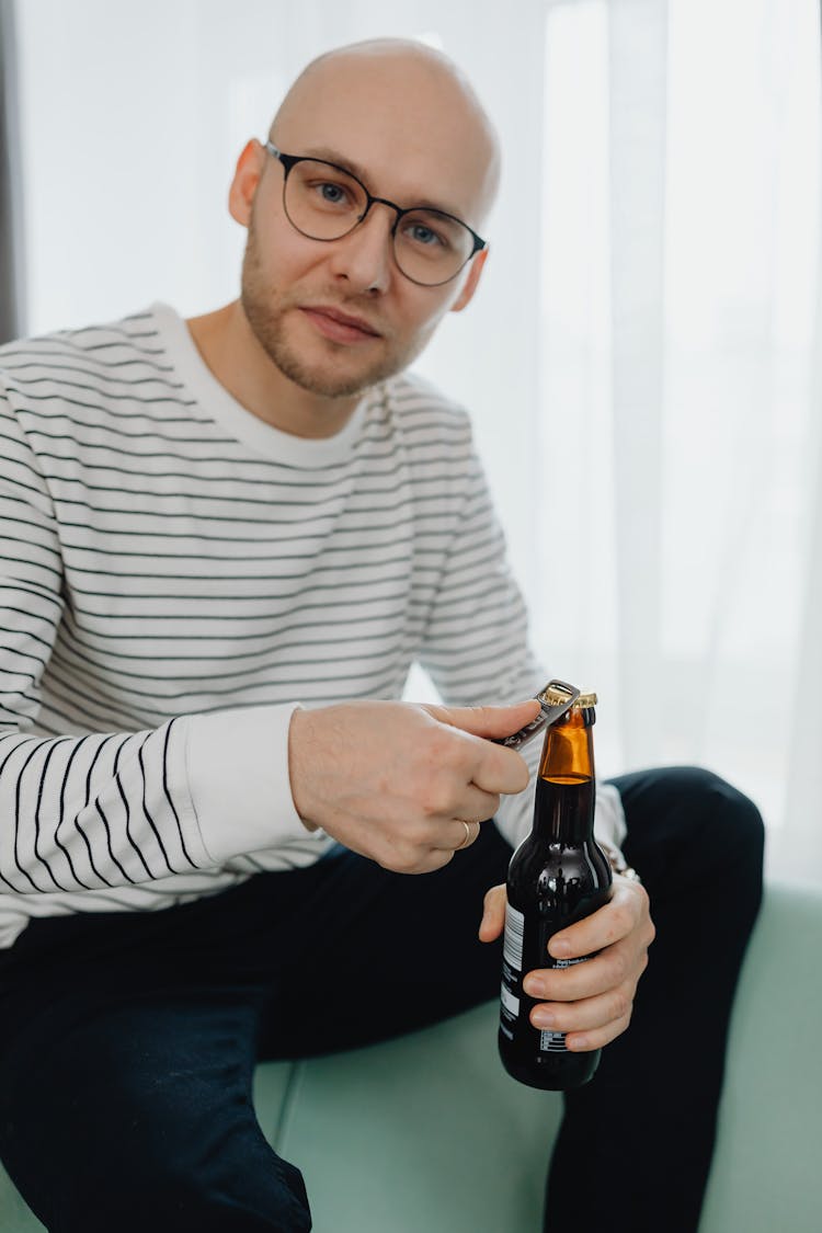 A Man Opening A Beer Bottle