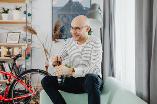 A Man Opening a Beer Bottle