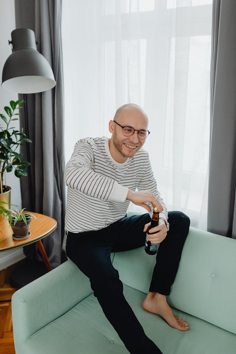 A Man Opening A Beer Bottle