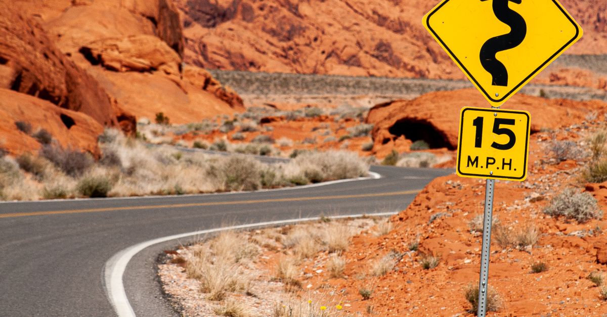 Yellow Rump Sign Road A Yellow Road Signs near the Curvy Road · Free Stock Photo