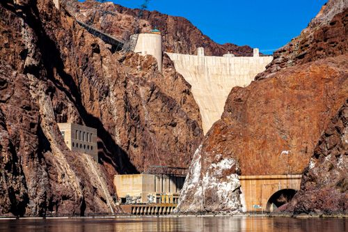 Free Stunning view of the Hoover Dam surrounded by rocky mountains under a bright blue sky. Stock Photo