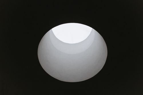 Free Dramatic low-angle shot of a circular ceiling opening creating unique shadows. Stock Photo