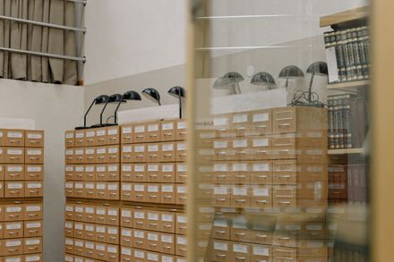 Wooden card-catalogue drawers under lamplight — photo by cottonbro studio on Pexels