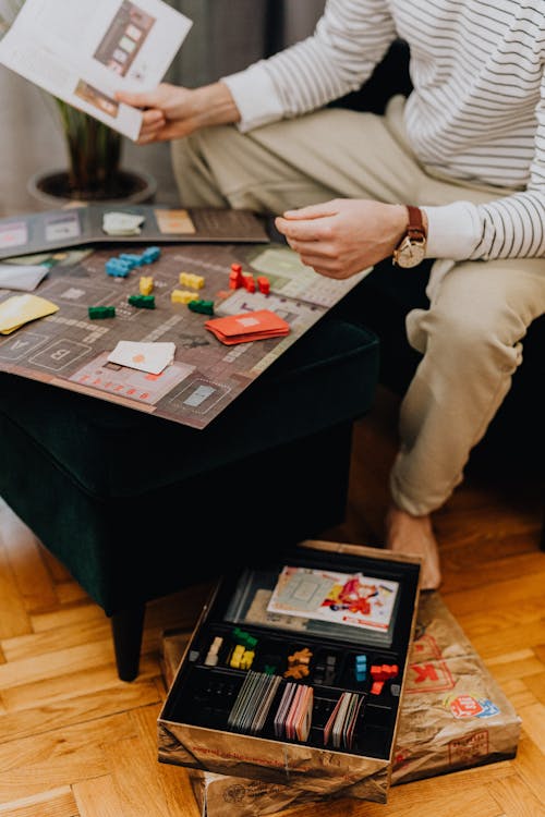 Close-up of Man Playing Board Game at Home